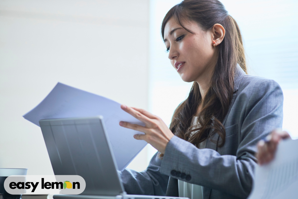 Person reviewing documents and repair records while preparing to use their ram truck recall lemon law rights.